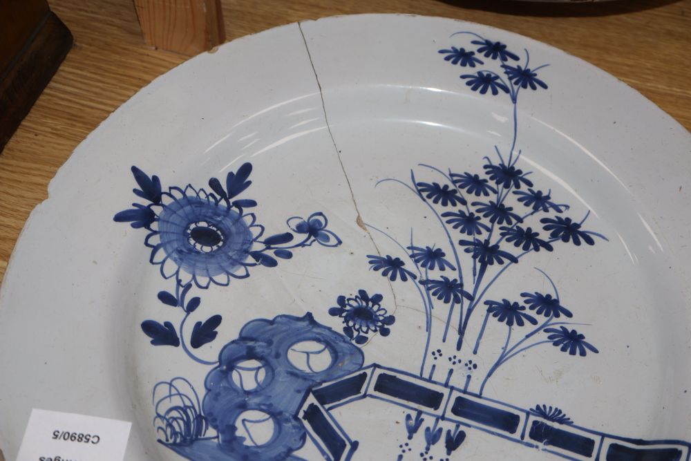 Four 18th century Delft blue and white dishes, largest 35cm (a.f.)